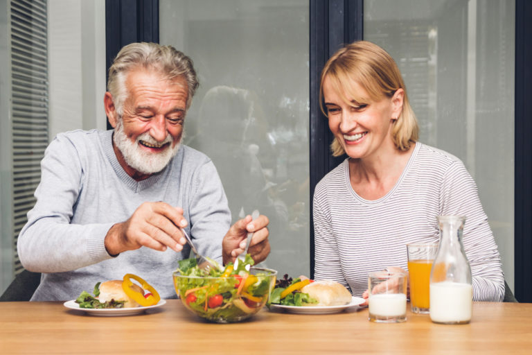 Senior couple enjoy eating  healthy breakfast together in the kitchen